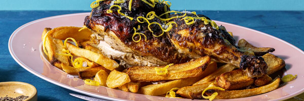 Lemon and Oregano Half-Chicken served over thick-cut fries.