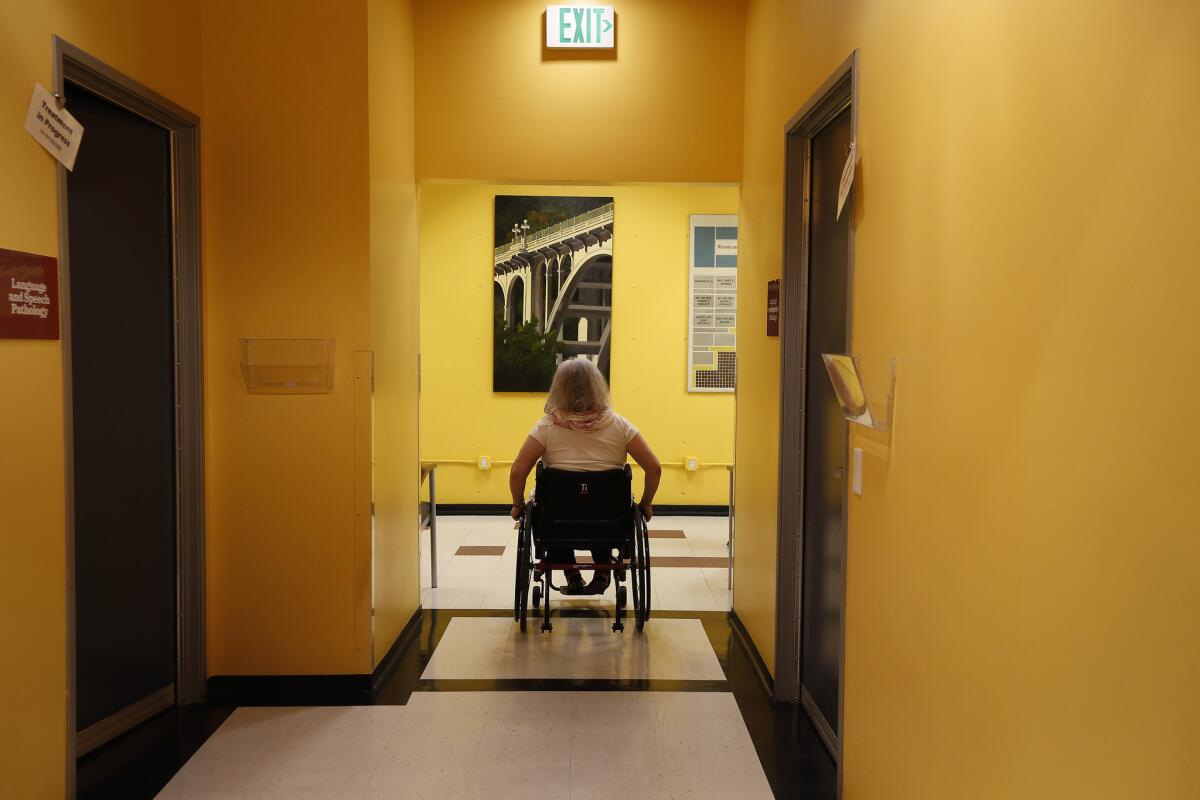 Following the first half of her physical therapy appointment, Missy Morris moves through Huntington Hospital's Rehabilitation Center in Pasadena.