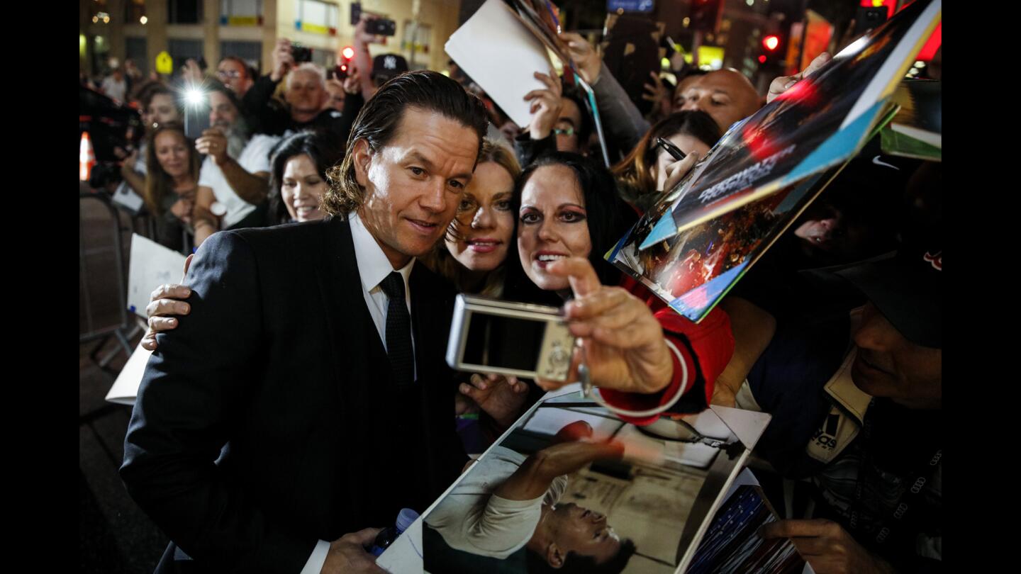 "Patriots Day" actor and producer Mark Wahlberg signs autographs and takes pictures with fans at the Boston Marathon bombing drama's premiere at the TCL Chinese Theatre in Hollywood during the AFI Fest.