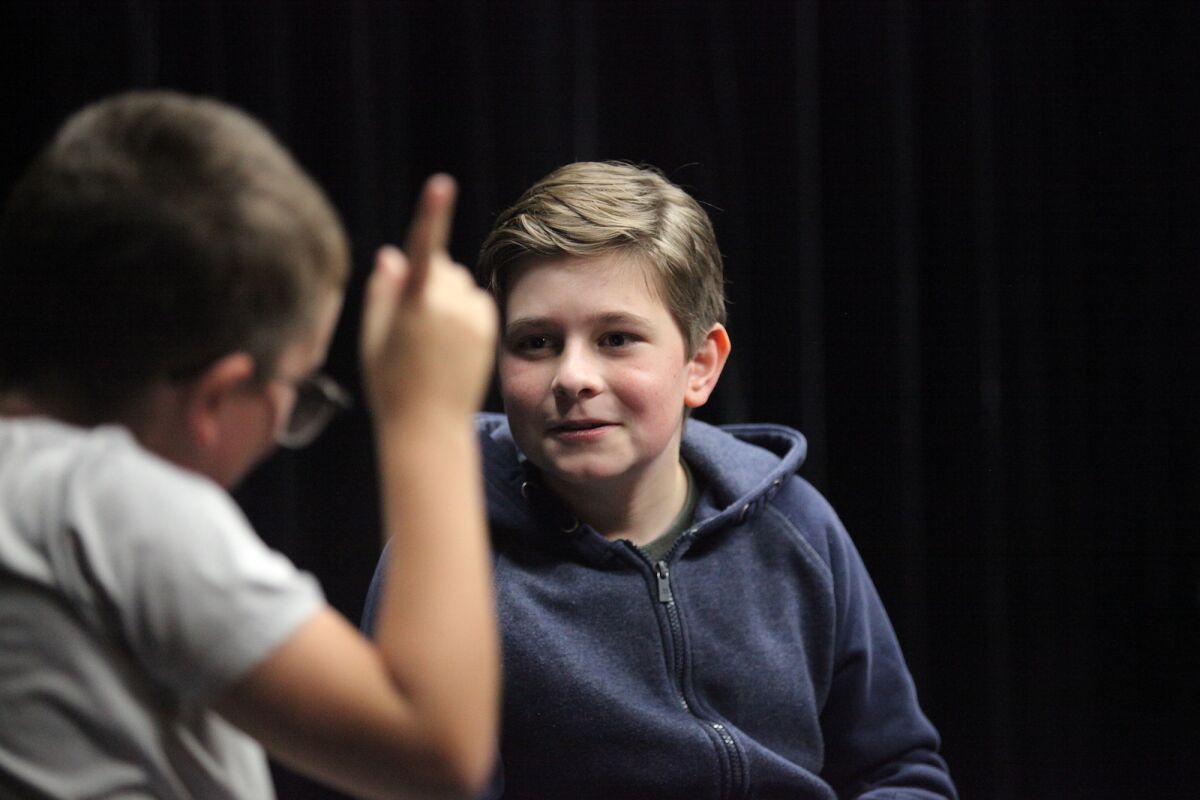 Max Fay, 13, right, improvises a scene with Guy Nelson, 10, at OC Crazies Improv class. 