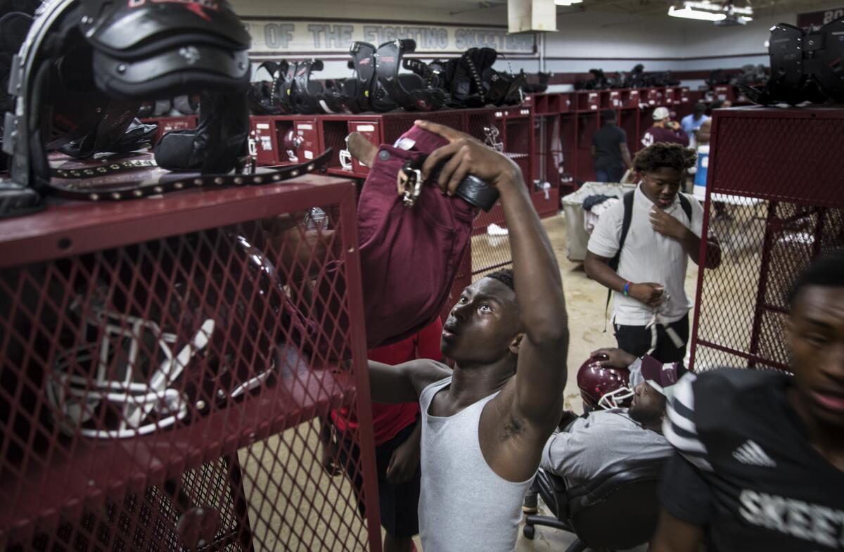 Ja’Darion Smith, 15, gets dressed after a recent practice. Since Jordan’s death, he finds comfort in prayer.