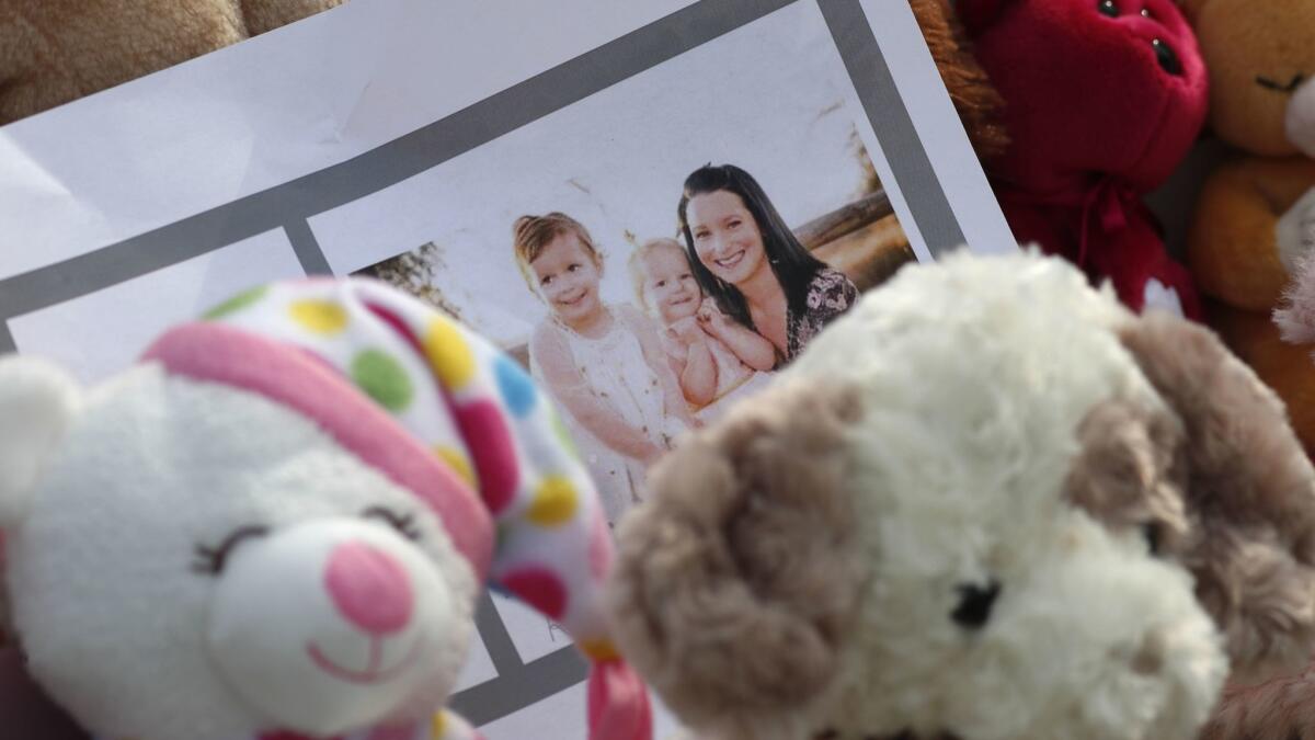 A tribute outside the home where Shanann Watts and her two daughters, Bella and Celeste, lived in Frederick, Colo., includes photos and stuffed animals,