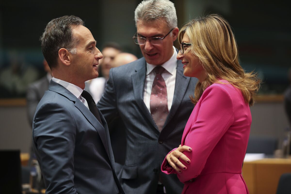 Germany's Foreign Minister Heiko Maas, left, talks to Bulgarian Foreign Minister Ekaterina Zaharieva, right, and Malta's Foreign Minister Carmelo Abela during an European Foreign Affairs Ministers meeting at the Europa building in Brussels, Monday, Nov. 11, 2019. European Union foreign ministers are discussing ways to keep the Iran nuclear deal intact after the Islamic Republic began enrichment work at its Fordo power plant. (AP Photo/Francisco Seco)