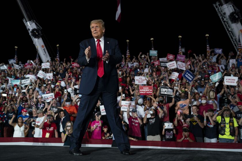 President Donald Trump walks off after speaking at a campaign rally at Orlando Sanford International Airport, Monday, Oct. 12, 2020, in Sanford, Fla. (AP Photo/Evan Vucci)