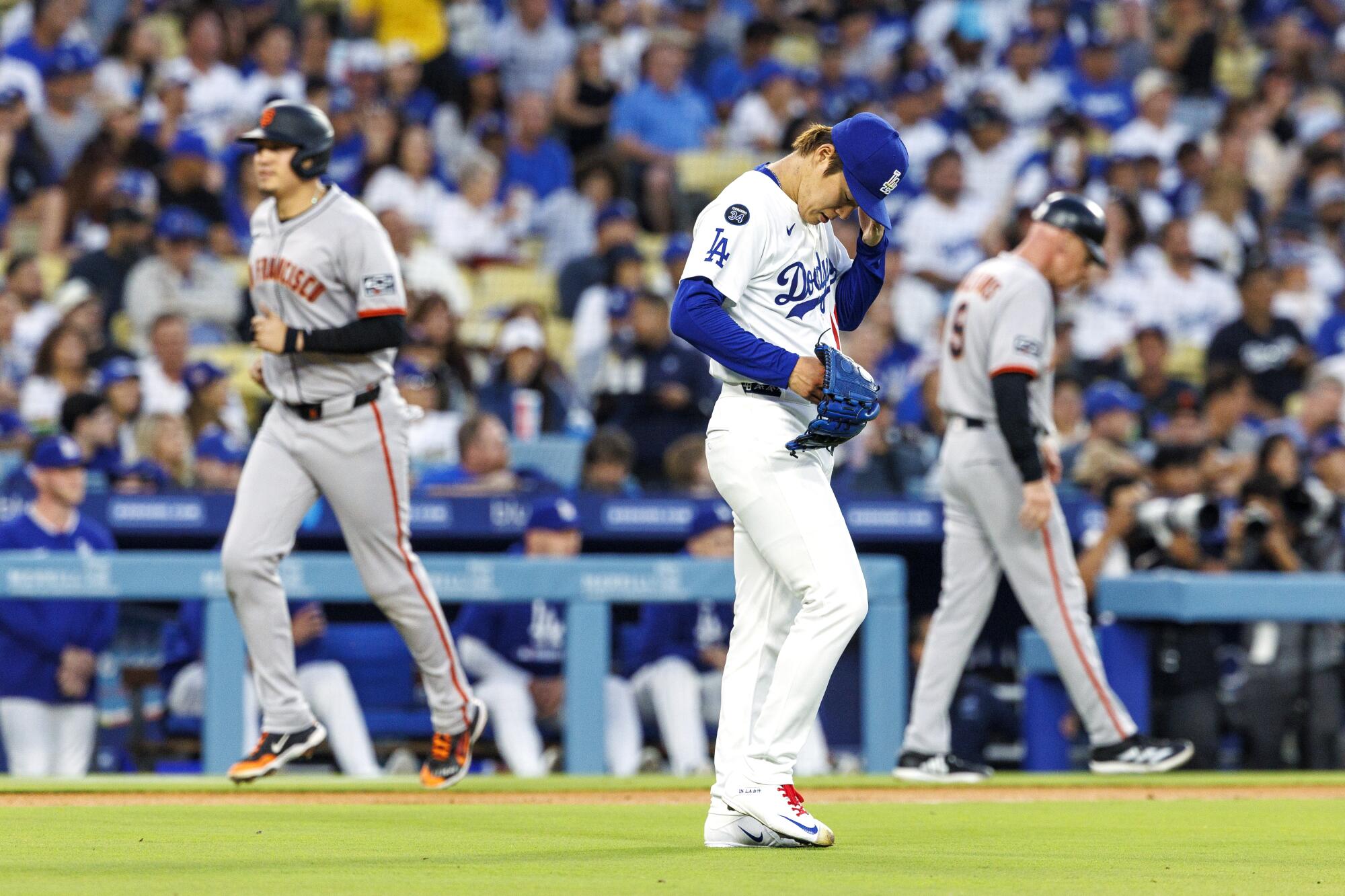 Dodgers pitcher Yoshinobu Yamamoto reacts after giving up a grand slam to San Francisco's Casey Schmitt.