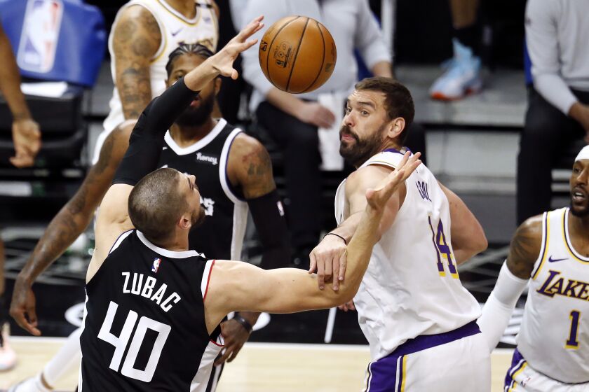 LOS ANGELES, CA - APRIL 04: LA Clippers center Ivica Zubac (40) and Los Angeles Lakers center Marc Gasol (14) fight for a loose ball in the first quarter at the Staples Center on Sunday, April 4, 2021 in Los Angeles, CA. (Gary Coronado / Los Angeles Times)