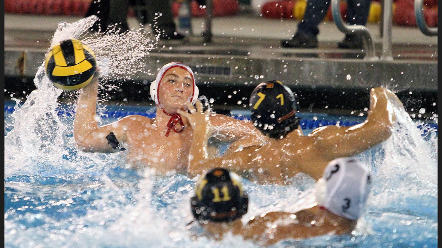 Burroughs' Aram Nordanyan shoots on La Canada's Alex Abrahamian in a CIF SS Division V boys' semifinal water polo match at Pasadena City College on Wednesday, November 16, 2016. Burroughs won the match and will advance to the championship.