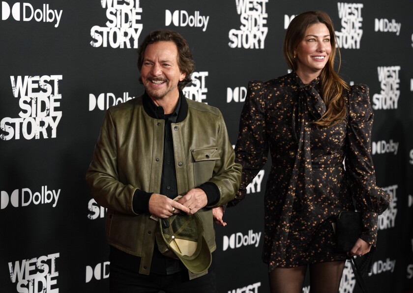 Pearl Jam singer Eddie Vedder and his wife Jill McCormick arrive at the premiere of the film "West Side Story," Tuesday, Dec. 7, 2021, at the El Capitan Theatre in Los Angeles. (AP Photo/Chris Pizzello)