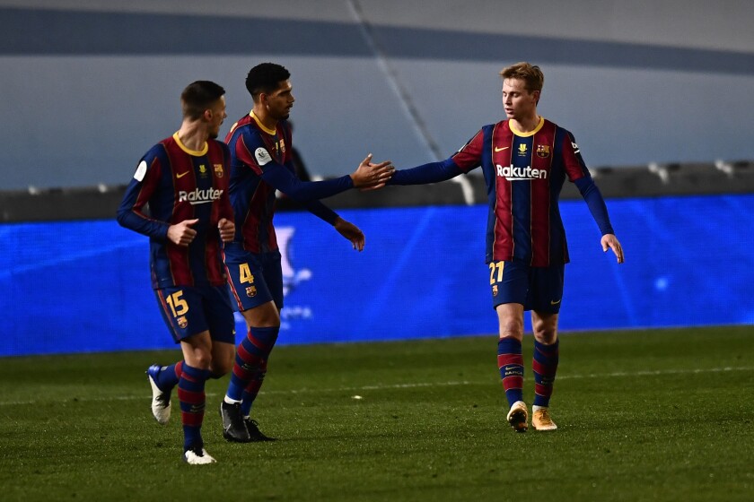 Barcelona's Frenkie de Jong celebrates with teammate Ronald Araujo after scoring.