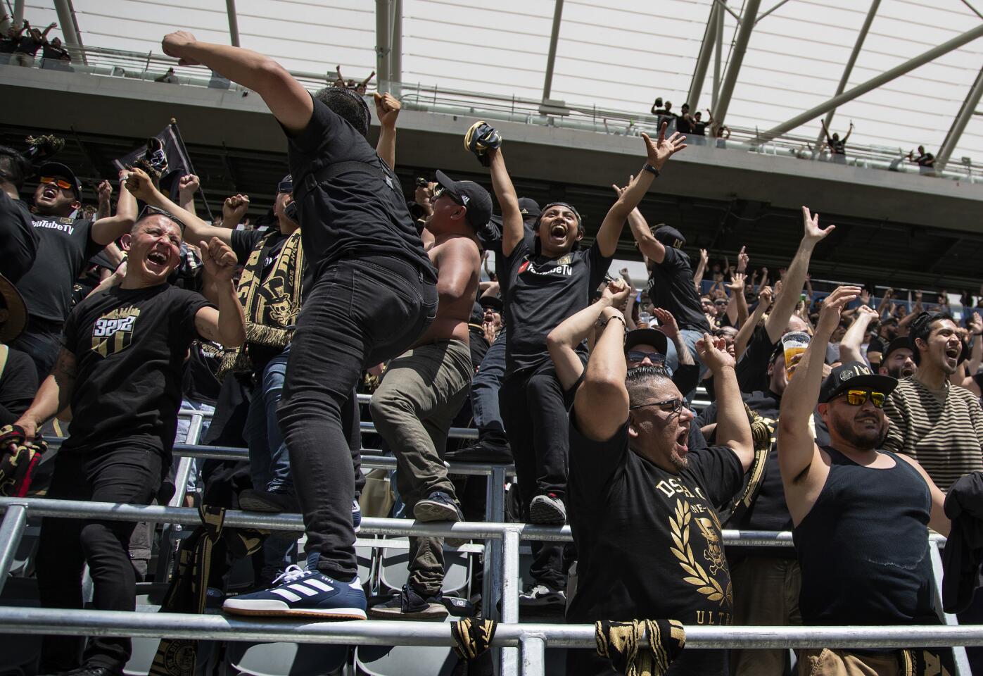 Fans cheer on LAFC during a screening of its game at Montreal in Banc of California Stadium on April 21.