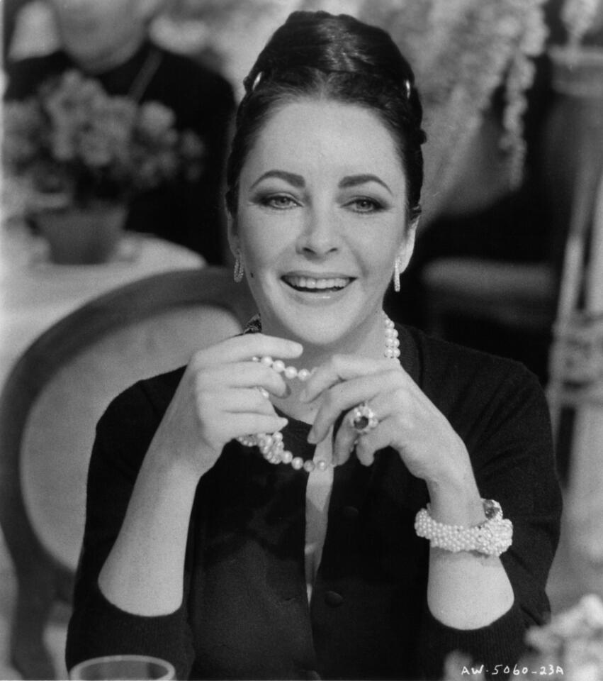 Elizabeth Taylor wore David Webb's jewelry: She's pictured in 1973 with the double-headed Lion Necklace and matching bracelet.