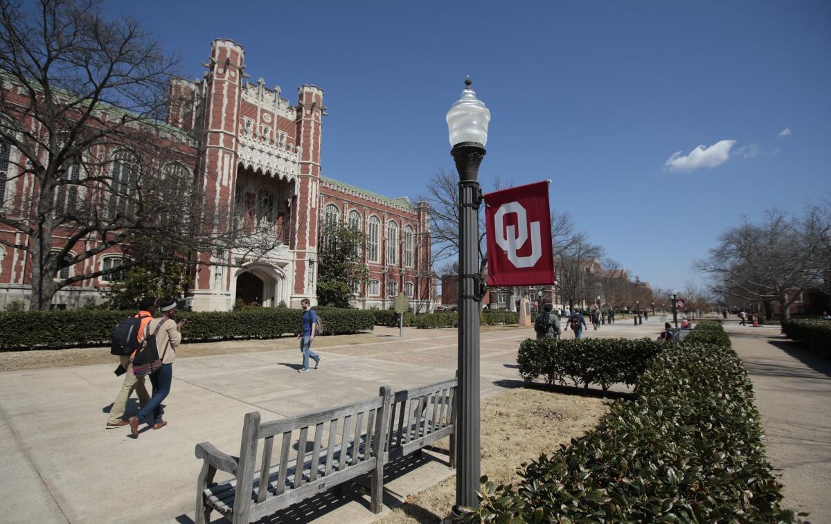 Students walk between classes in front of the Bizzell Memorial Library at the University of Oklahoma. Video showing Sigma Alpha Epsilon members singing a racist chant went viral after being uploaded to the Internet.