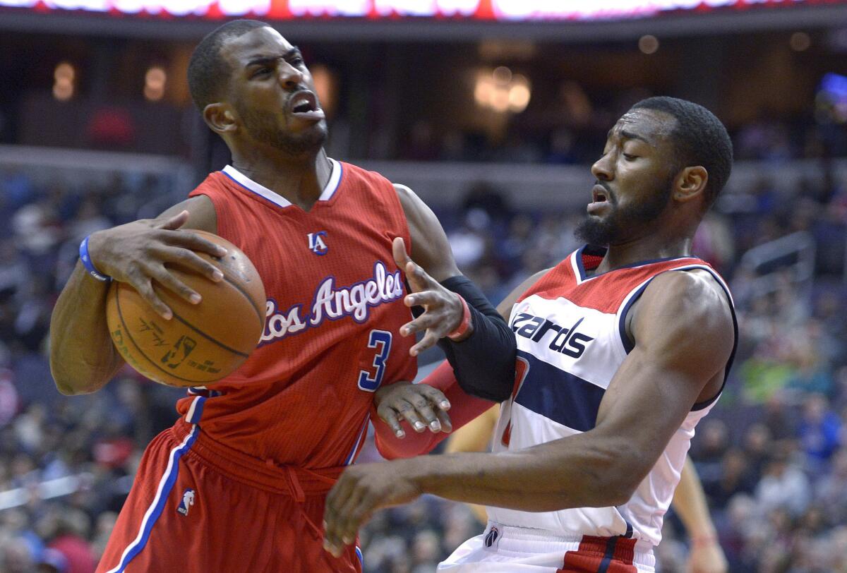 Chris Paul and Washington's John Wall battle on the court during the first half of the Clippers' 104-96 loss to the Wizards at Verizon Center in Washington, D.C.