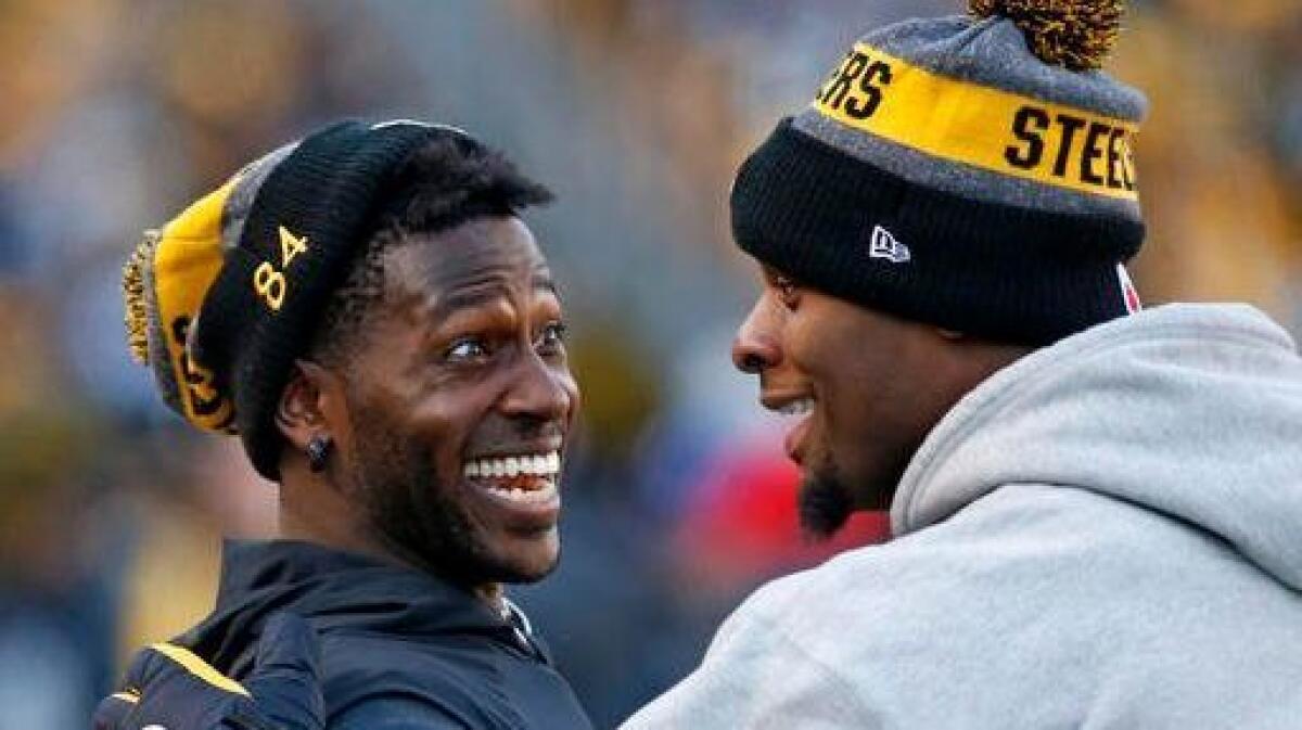 Steelers wide receiver Antonio Brown, left, and running back Le'Veon Bell celebrate on the sideline after a Steelers touchdown during the second half of a game against the Cleveland Browns on Jan. 1.