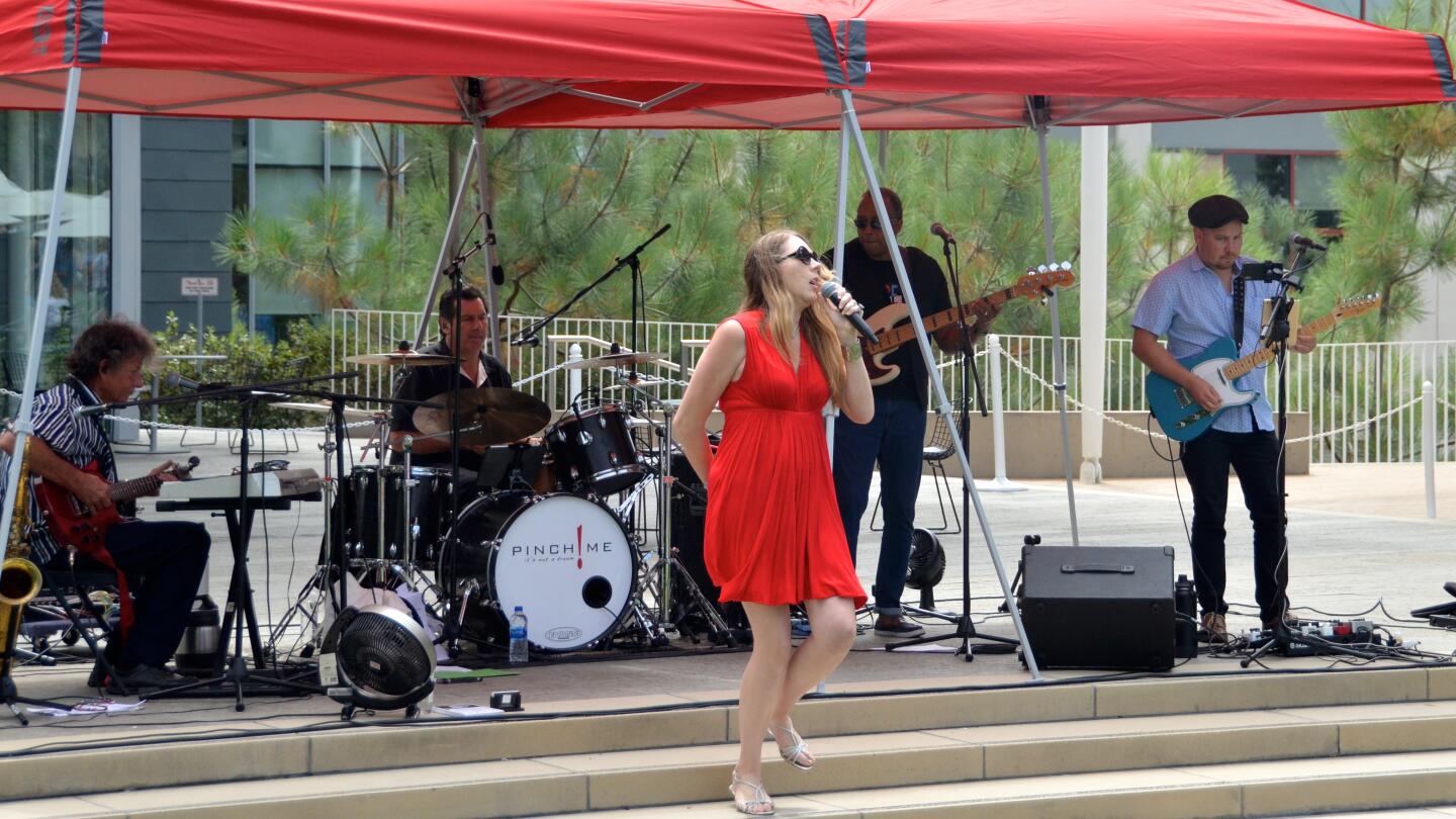 Pinch Me provides entertainment during Lobsterfest on Sunday at the Newport Beach Civic Center green.