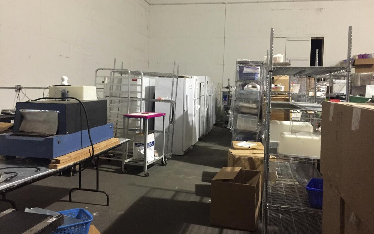 Refrigerators and other medical lab equipment inside a now-shuttered lab.