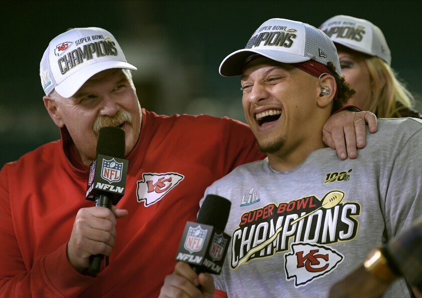 Kansas City Chiefs head coach Andy Reid, left, and quarterback Patrick Mahomes speak during a television interview after defeating the San Francisco 49ers in the NFL Super Bowl 54 football game Sunday, Feb. 2, 2020, in Miami Gardens, Fla. (AP Photo/Mark J. Terrill)