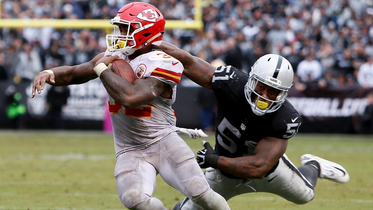 Chiefs running back Spencer Ware, breaking a tackle by Raiders linebacker Bruce Irvin, rushed for 131 yards Sunday.