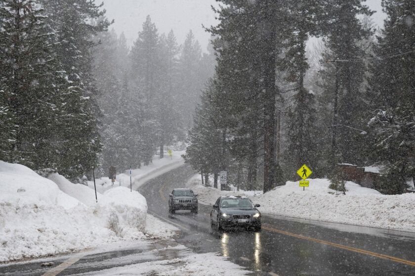 FILE - Vehicles move swiftly as snow falls on Highway 89 along the west shore of Lake Tahoe near Tahoma, Calif., on Thursday, Jan. 5, 2023. The California Department of Water Resources says the water content in the statewide snowpack on Wednesday, Feb. 1, 2023, is 205% of normal to date and 128% of the April 1 average, its historical peak. (Nathaniel Levine/The Sacramento Bee via AP, File)