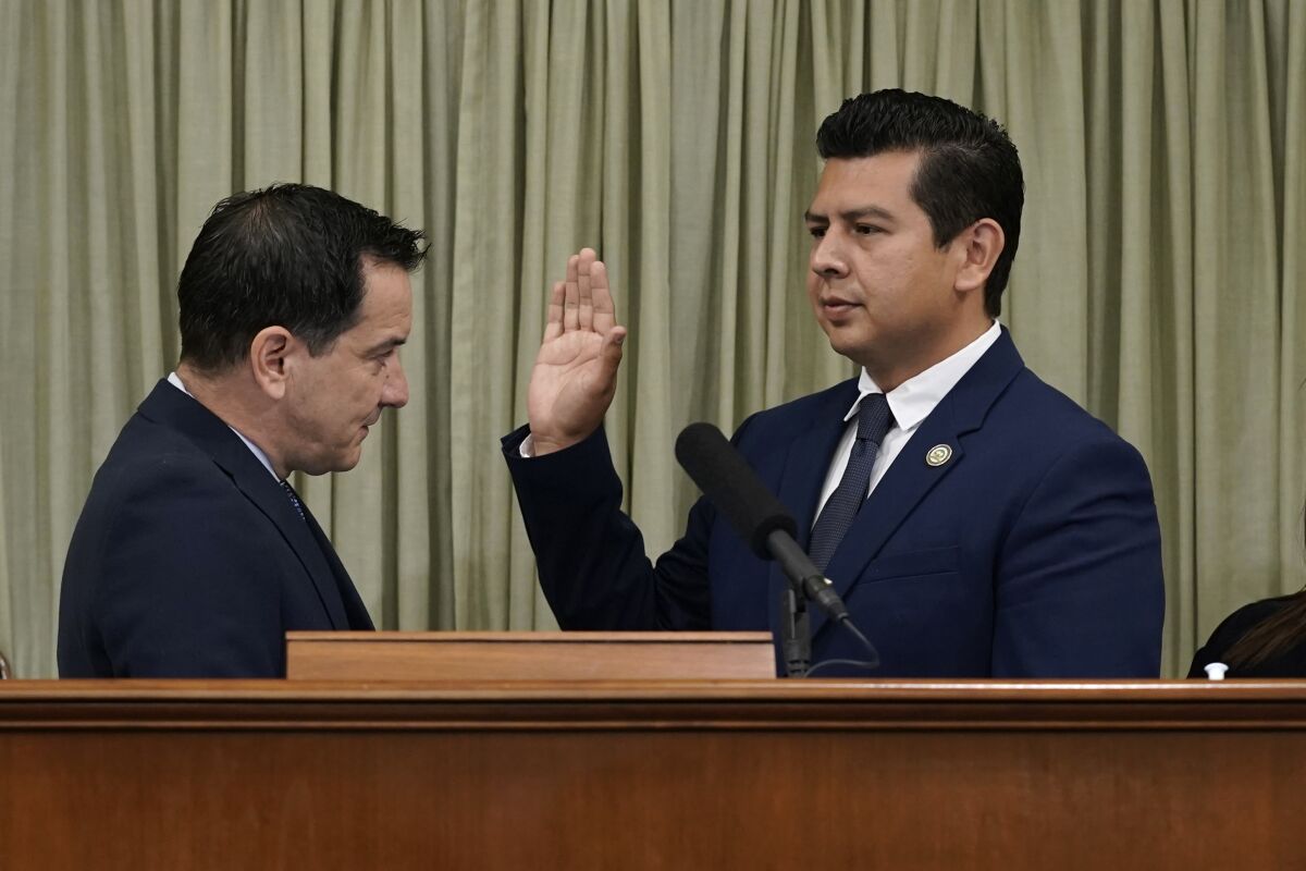 David Alvarez, second from left, is sworn into the California Assembly by Assembly Speaker Anthony Rendon, l