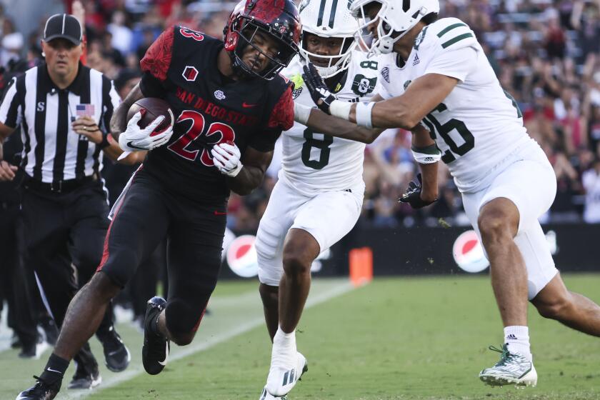 San Diego, CA - August 26: San Diego State Aztecs running back Kenan Christon (23) is pushed out of bounds by Ohio Bobcats safety Walter Reynolds (26) during their game at Snapdragon Stadium on Saturday, Aug. 26, 2023 in San Diego, CA. (Meg McLaughlin / The San Diego Union-Tribune)