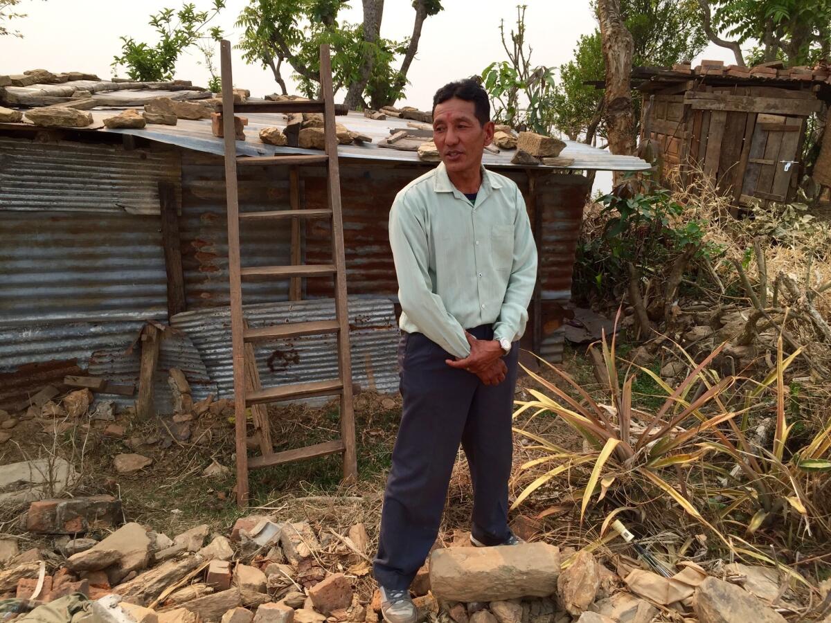 Raj Kumar Sahi outside his temporary home in Paslang, Nepal.