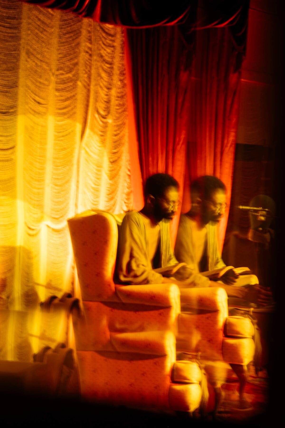 Double exposure of a man sitting in a chair at Mid City Yacht Club