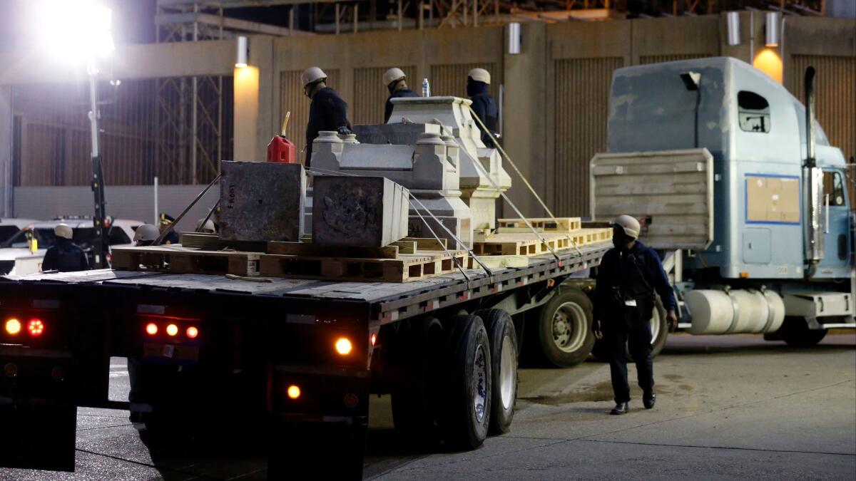 Workers dismantle the Liberty Place monument in New Orleans on April 24, 2017. The monument commemorated whites who tried to topple a biracial post-Civil War government.