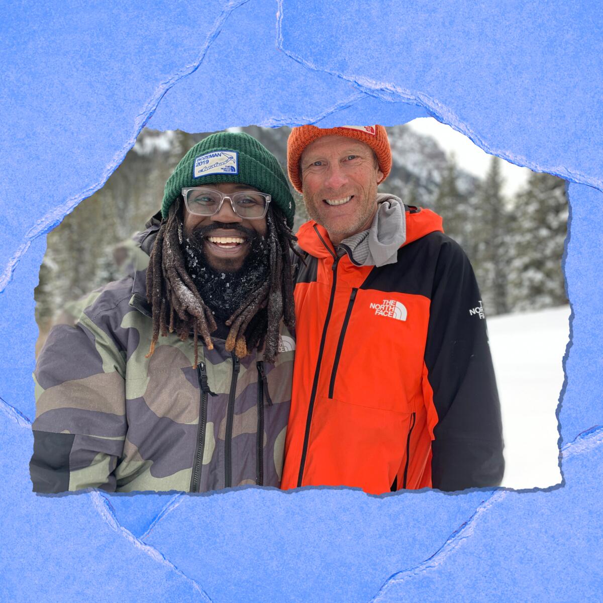 Two men in winter coats and beanies smile as they pose for a photo against a snowy outdoor backdrop.