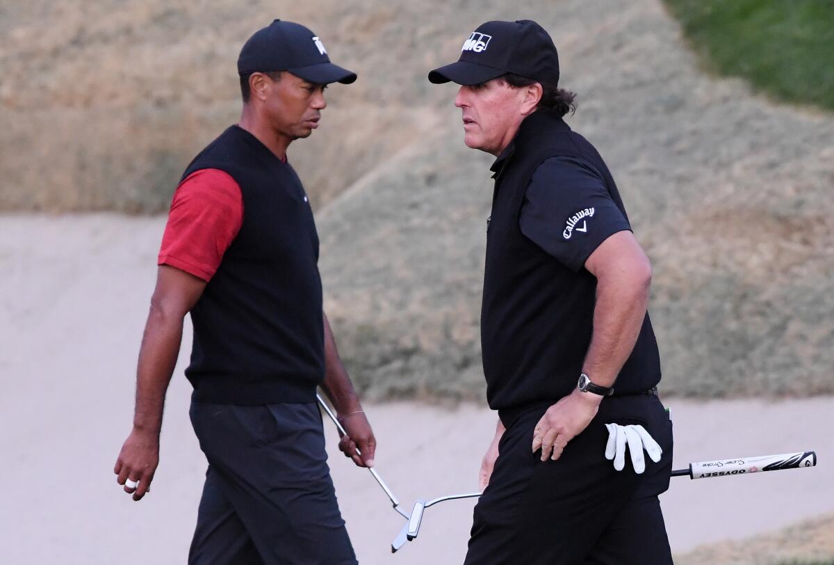 Tiger Woods, left, and Phil Mickelson on the 18th hole during The Match: Tiger vs. Phil on Nov. 23, 2018, at Shadow Creek Golf Course.