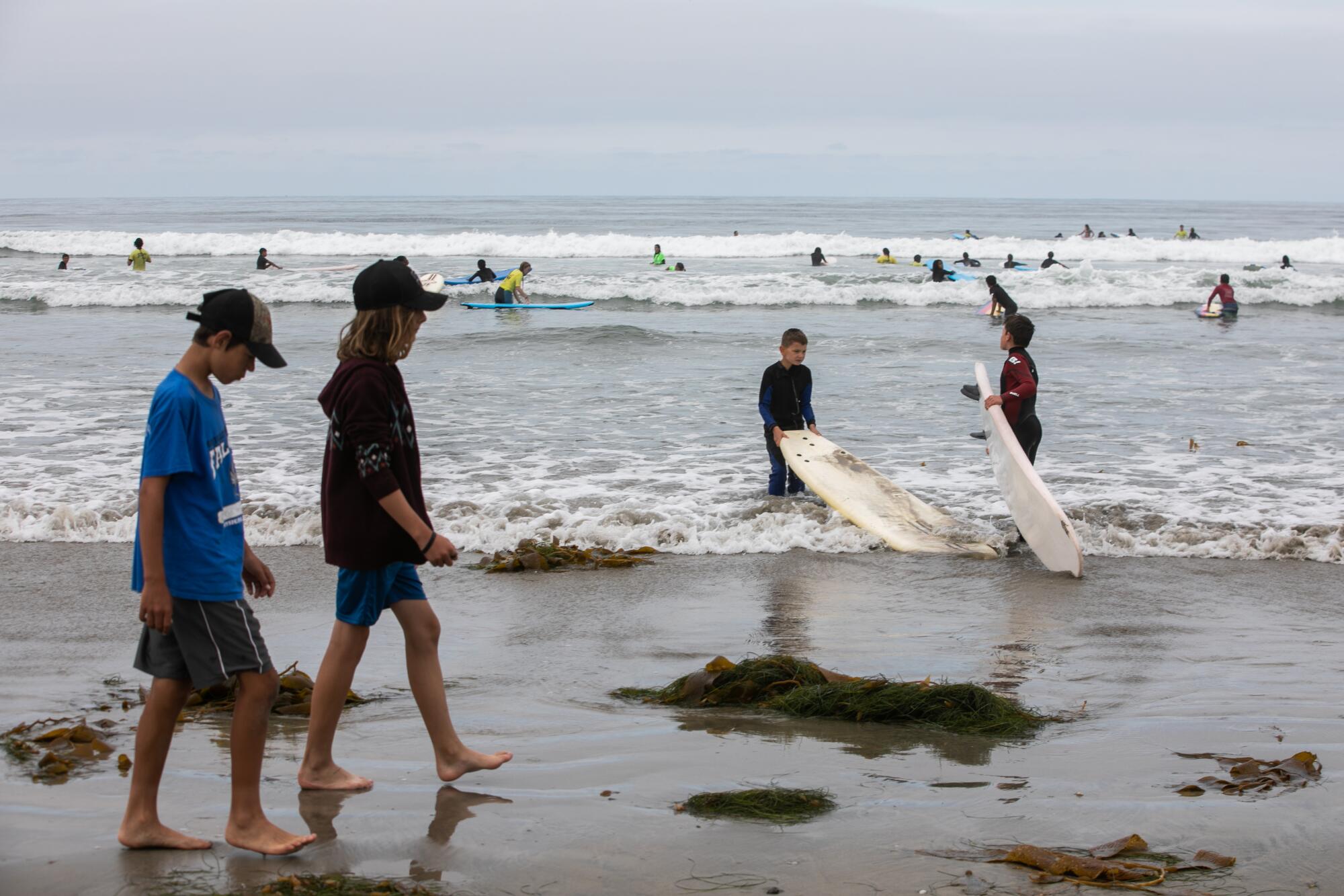 YMCA Surf Camp students play and surf at Silver Strand Beach just north of Imperial Beach on Friday.