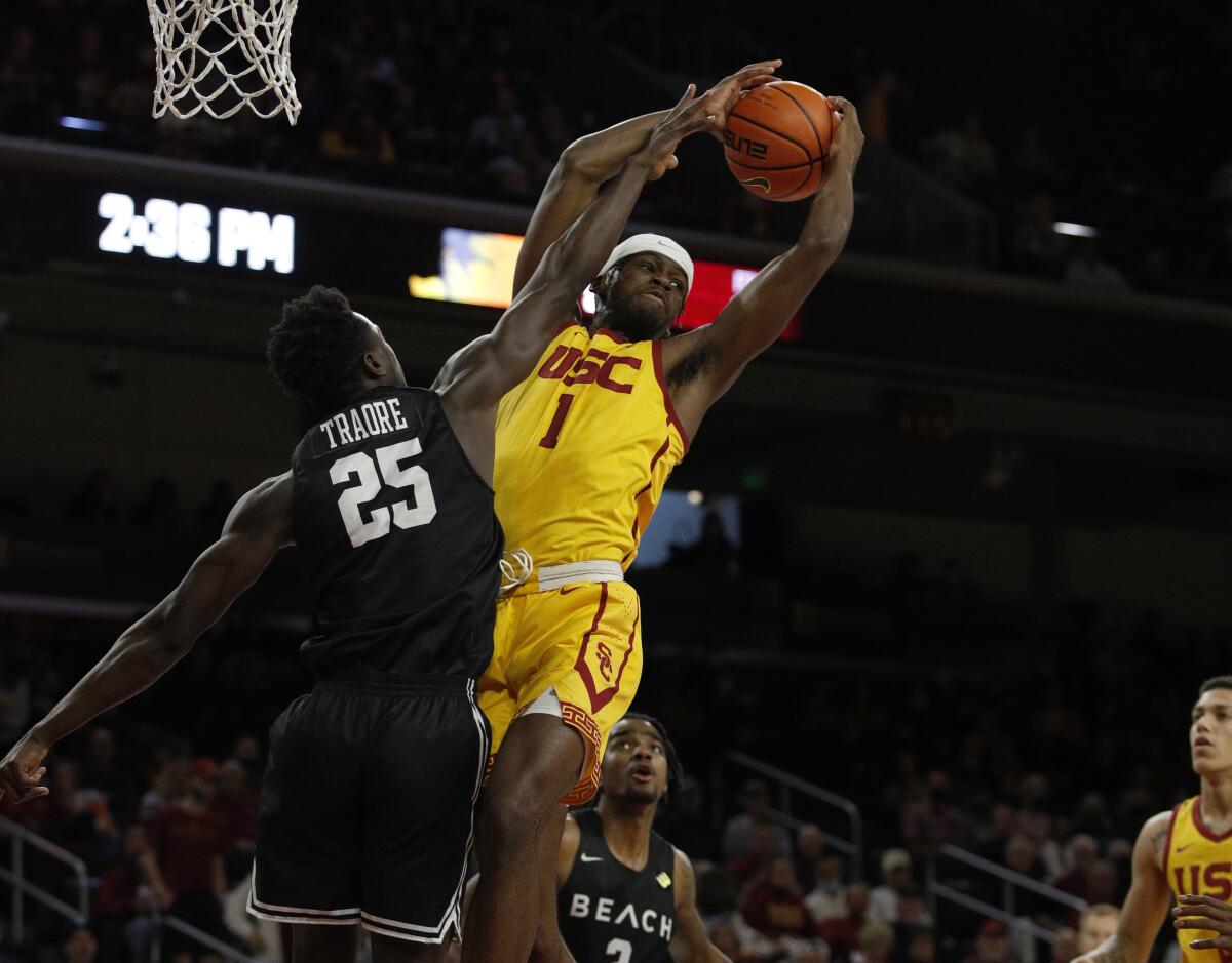 USC forward Chevez Goodwin (1) grabs an offensive rebound in front of Long Beach State's Aboubacar Traore