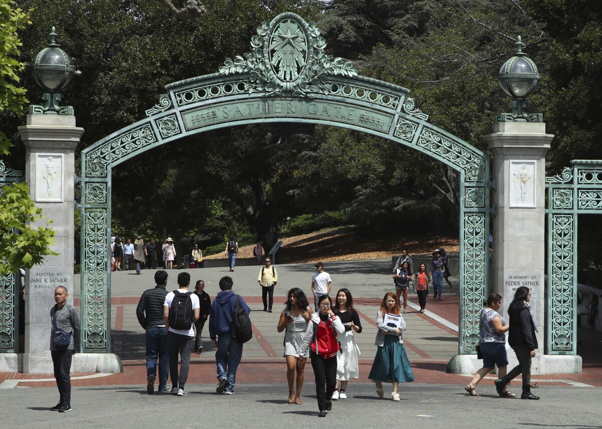 Students walk past Sather Gate on the University of California at Berkeley campus in Berkeley.