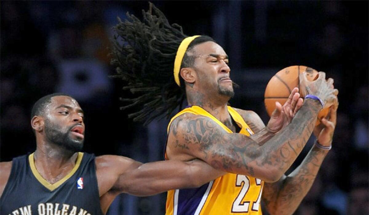 Jordan Hill grabs a rebound in front of New Orleans' Tyreke Evans during the Lakers' 116-95 win over the Pelicans on Nov. 12.