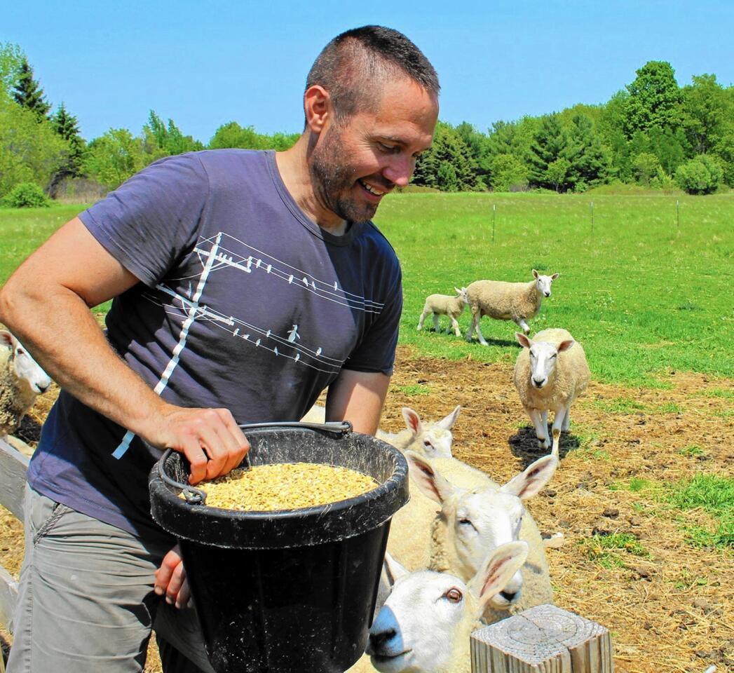 Darrin Day feeds part of his flock at the Chanticleer Guest House, near Sturgeon Bay, Wis.