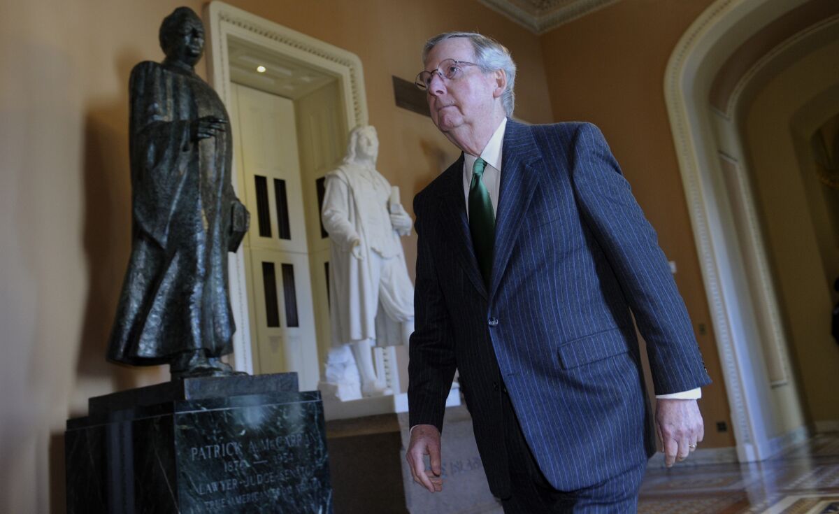 Senate Minority Leader Mitch McConnell (R-Ky.) heads to the Senate floor on Capitol Hill. McConnell and Majority Leader Harry Reid (D-Nev.) have worked out a cease-fire in the battle between Senate Republicans and Democrats over new rules that limit filibusters.