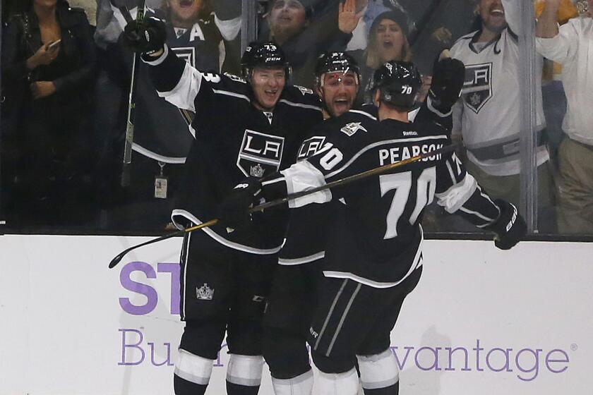 Kings defenseman Alec Martinez ,middle, celebrates his game-winning goal in overtime with teamates Tyler Toffoli, left, and Tanner Pearson (70) on Oct. 25.