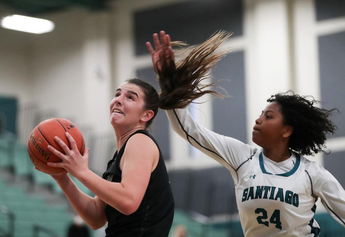 Sage Hill's Emily Eadie, left, seen against Corona Santiago on March 8, eclipsed 1,000 career points on Thursday.