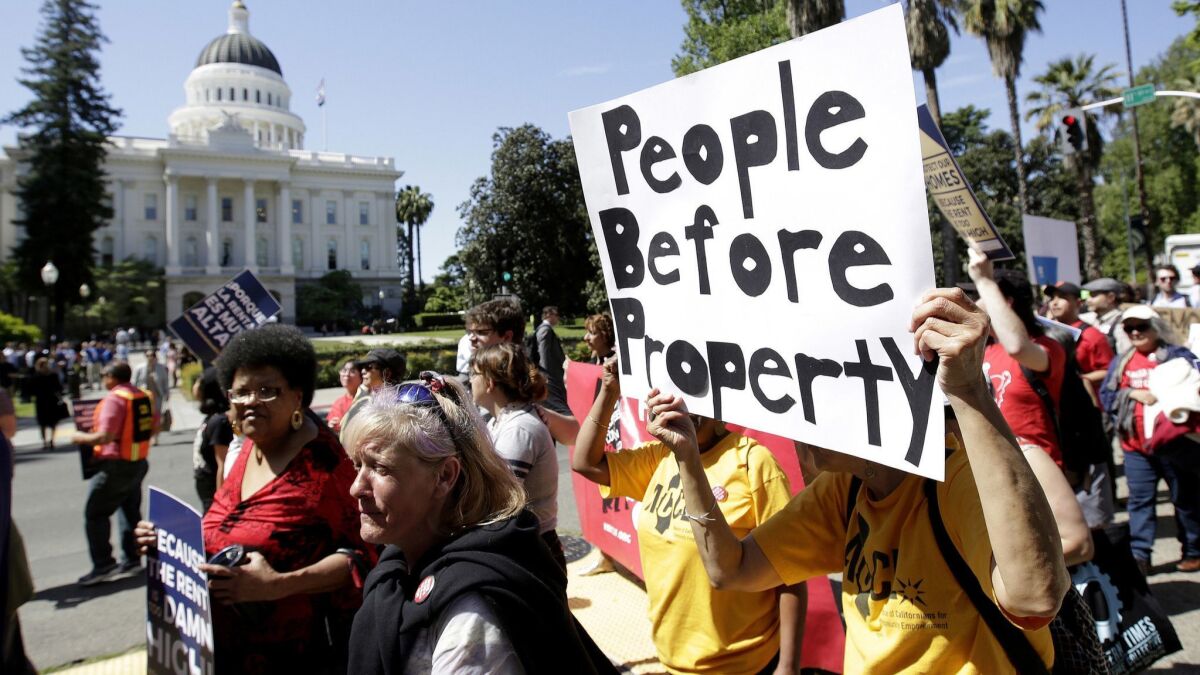 Rent-control supporters last year march past the Capitol in Sacramento.