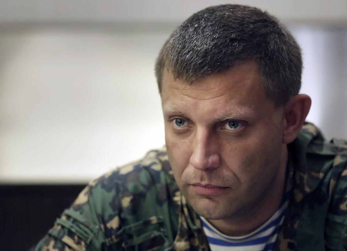 Separatist leader Alexander Zakharchenko listens at a news conference in Donetsk, Ukraine.