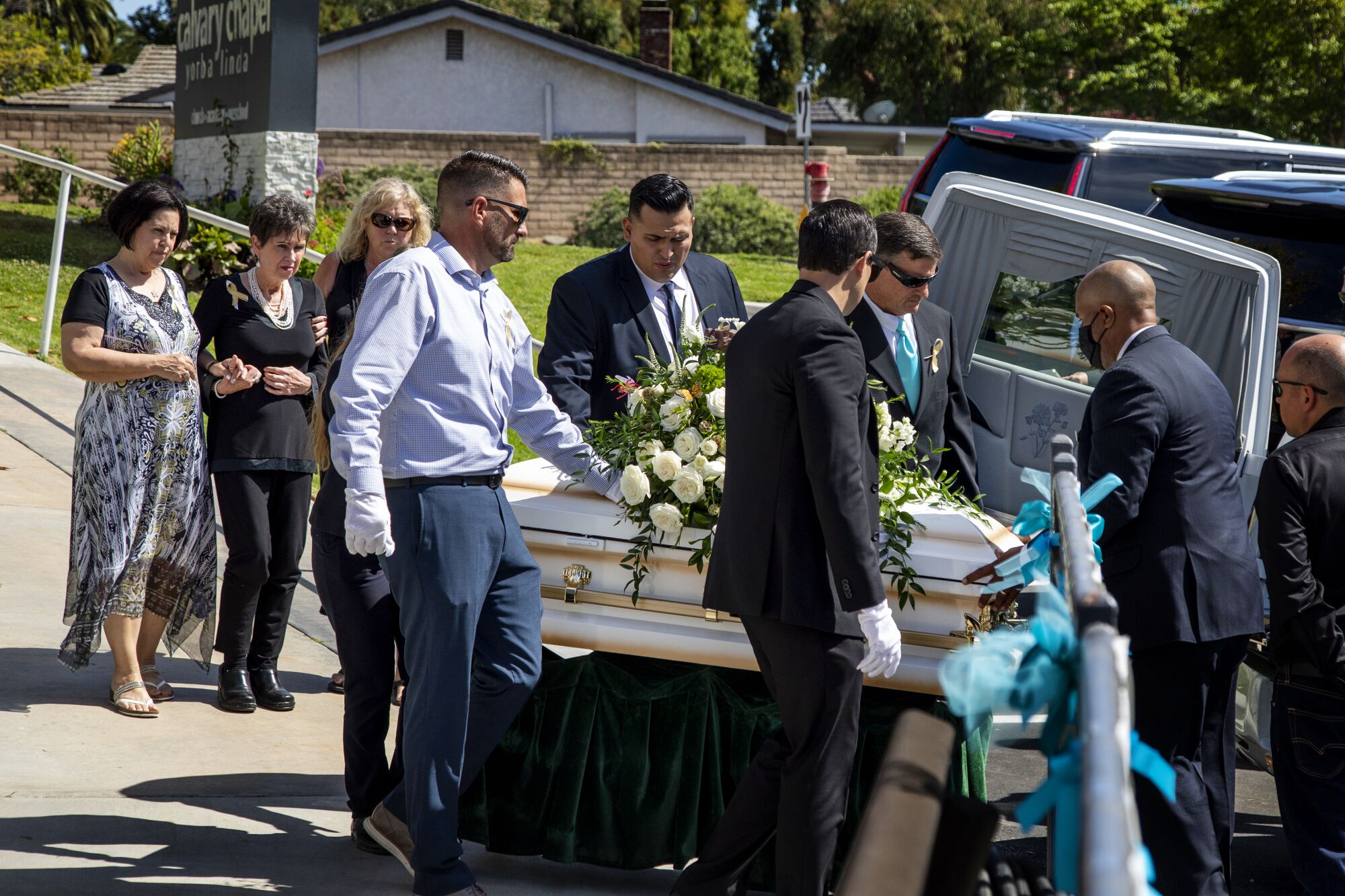 Family members walk behind the casket of 6-year-old Aiden Leos.
