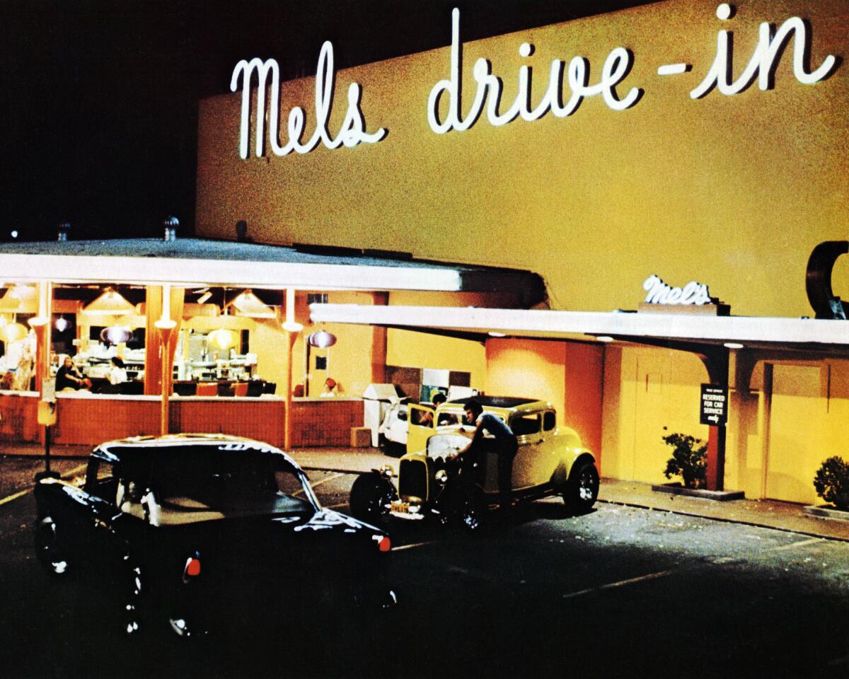 A night-time scene outside Mel's Drive-In in San Francisco from the film 'American Graffiti', 1973.