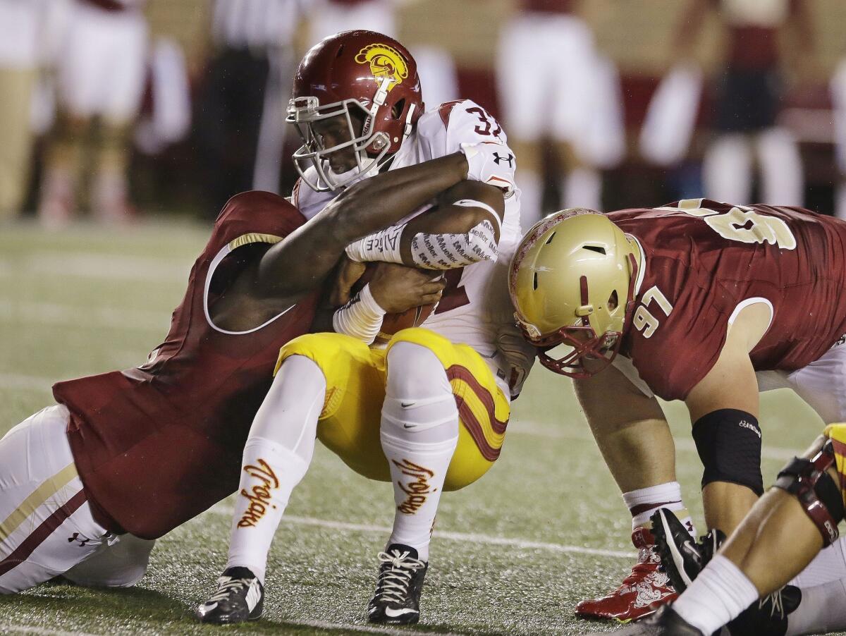 USC running back Javorius Allen is tackled by Boston College linebacker Steven Daniels, left, and defensive tackle Truman Gutapfel on Saturday night in Boston.