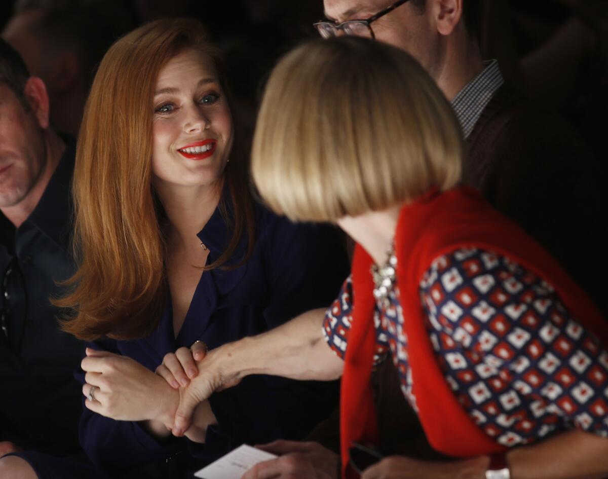 Actress Amy Adams, left, talks with Anna Wintour editor of American Vogue as they attend Max Mara women's spring-summer 2015 fashion show at Milan Fashion Week on Sept. 18.