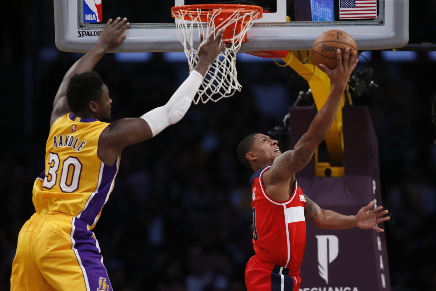 Washington Wizards guard Bradley Beal, right, gets past Lakers forward Julius Randle to score during the second half.