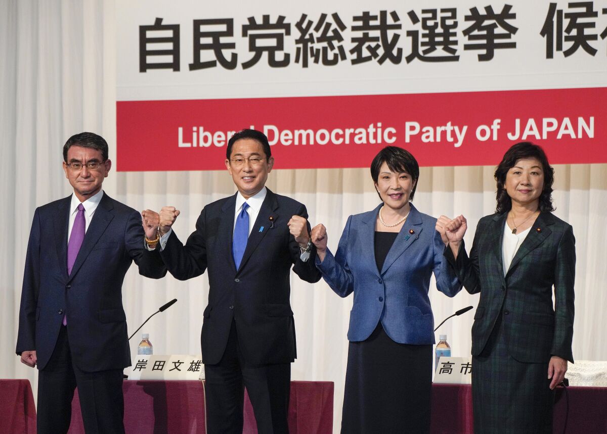 Candidates for the presidential election of the ruling Liberal Democratic Party pose prior to a joint news conference at the party's headquarters in Tokyo, Japan, Friday, Sept. 17, 2021. The contenders are from left to right, Taro Kono, the cabinet minister in charge of vaccinations, Fumio Kishida, former foreign minister, Sanae Takaichi, former internal affairs minister, and Seiko Noda, former internal affairs minister. Official election campaigning kicked off Friday for the new head of Japan’s governing party LDP, whose winner is almost assured to become next Japanese prime minister.(Kimimasa Mayama/Pool Photo via AP)