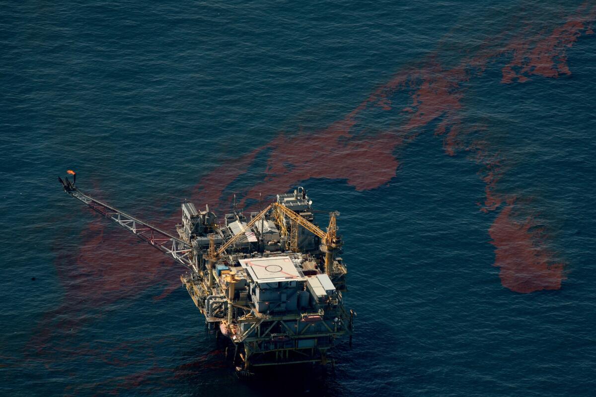 Streams of oil flow by an oil production platform toward the Louisiana coastline in the Gulf of Mexico in May 2010.