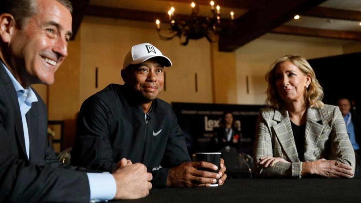 Businessman and philanthropist Doug Kimmelman, left, professional golfer Tiger Woods, center, and tennis great Chris Evert.