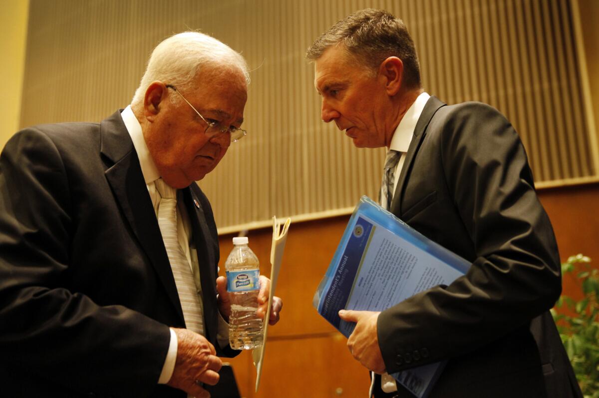 School board president Richard Vladovic, left, confers with L.A. schools Supt. John Deasy at an event last year. On Tuesday, Vladovic's colleagues again chose him to serve as president.