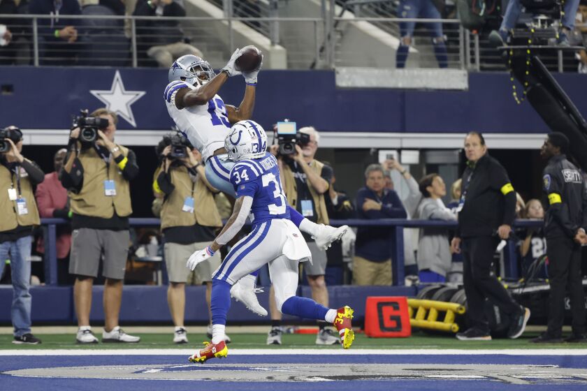 Dallas Cowboys' Michael Gallup (13) makes a touchdown catch against Indianapolis Colts' Isaiah Rodgers (34) during the second half of an NFL football game, Sunday, Dec. 4, 2022, in Arlington, Texas. (AP Photo/Michael Ainsworth)